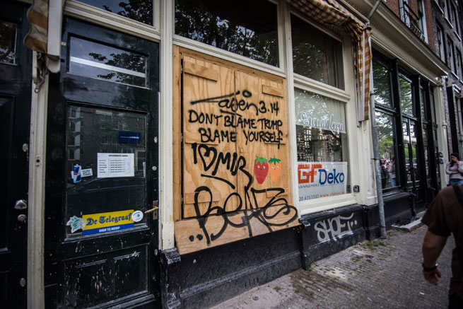 Graffiti reading 'don't blame Trump, blame yourself' painted on a Dutch shop window