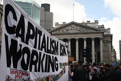 A banner reading "Capitalism isn't working" (a pun on the Conservative election poster "Labour isn't working") at the G20 Meltdown protest in London on 1 April 2009