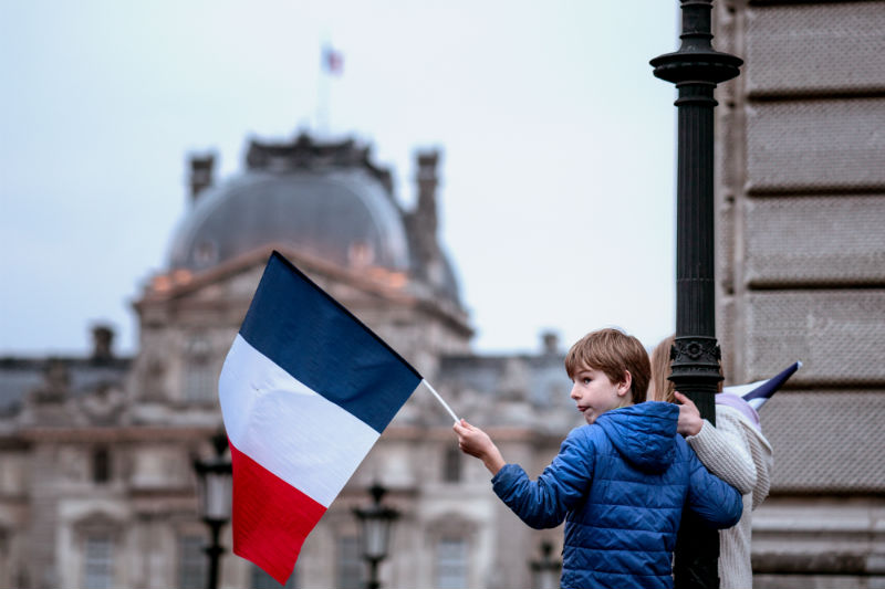 A child celebrates Emmanuel Macron's victory in the 2017 French Presidential election