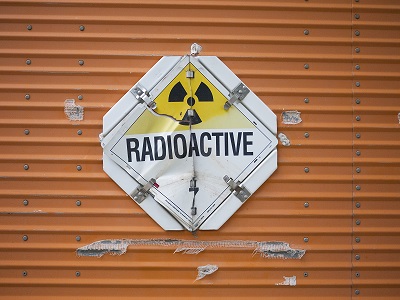 Battered sign on a truck carrying radioactive material