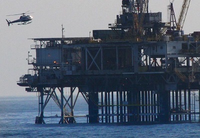 A helicopter flies to an oil rig in the North Sea
