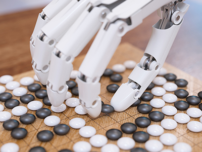 Robot hand controlled by Artificial intelligence playing traditional board game Go.