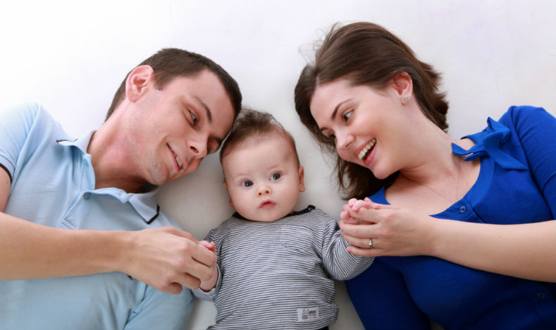 Image of two parents with their baby between them