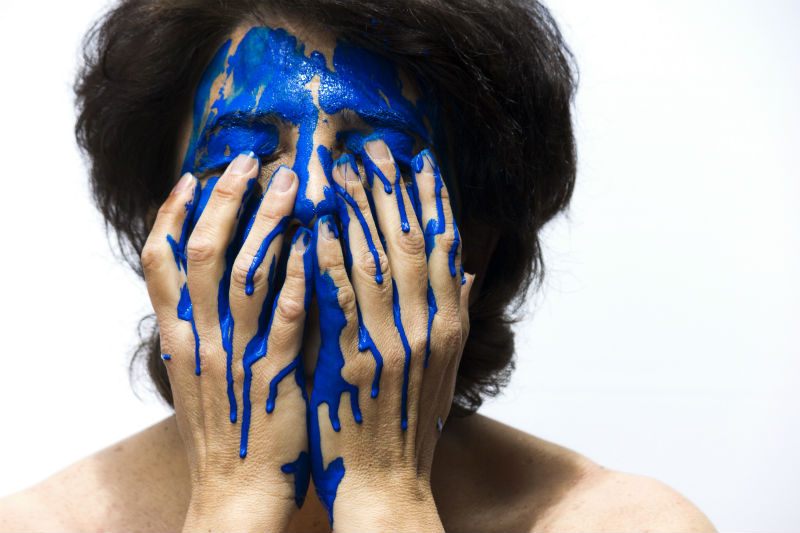A person with blue paint on their face