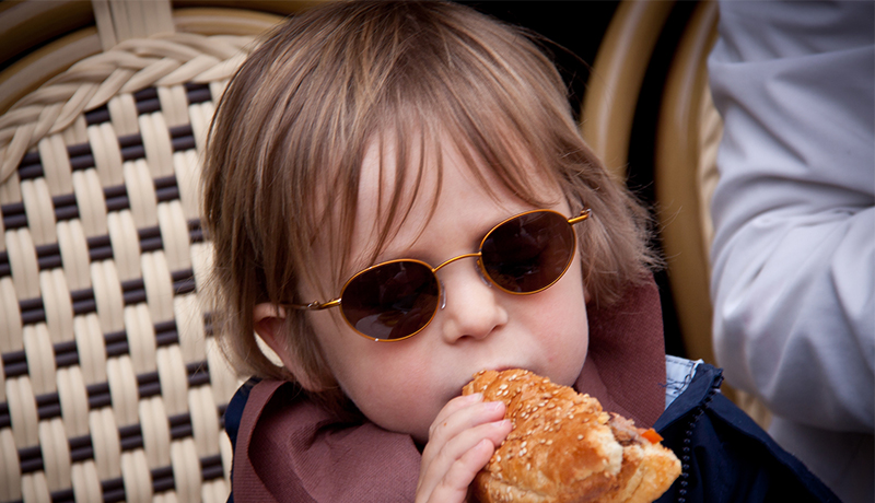 Young child eating a burger