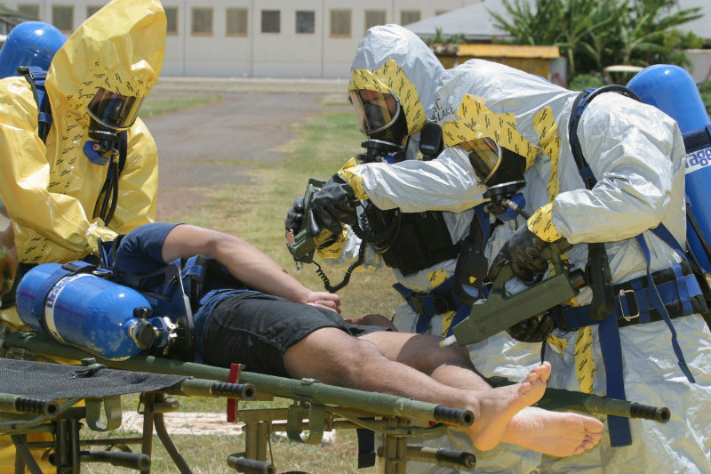 Members of the 93rd Weapons of Mass Destruction Civil Support Team (WMD CST) scan a survey team member for nerve or blister agents with chemical detection equipment during a casualty evacuation drill. 