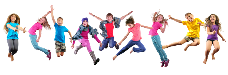 Large group of happy children exercising, jumping and having fun.
