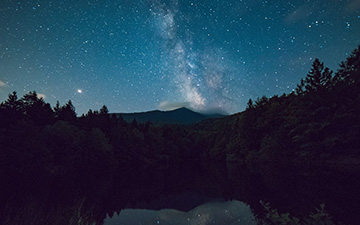 View of mountains against the sky and moon at night
