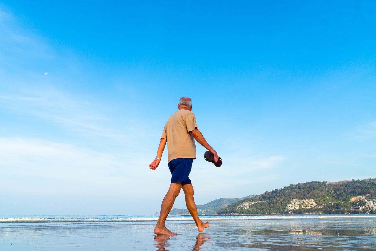 senior man walking on the beach