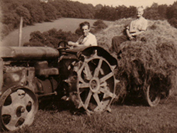 farmers on a tractor haymaking during the 1950s post-war agricultural revolution