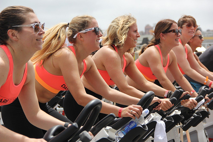 line of women on exercise bikes