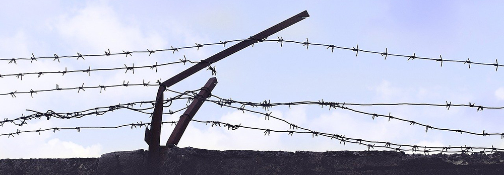 Barbed wire fencing on a prison wall
