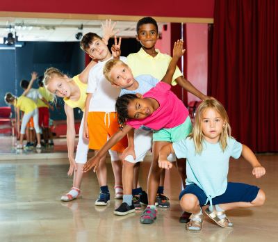 Happy children posing at modern dance class