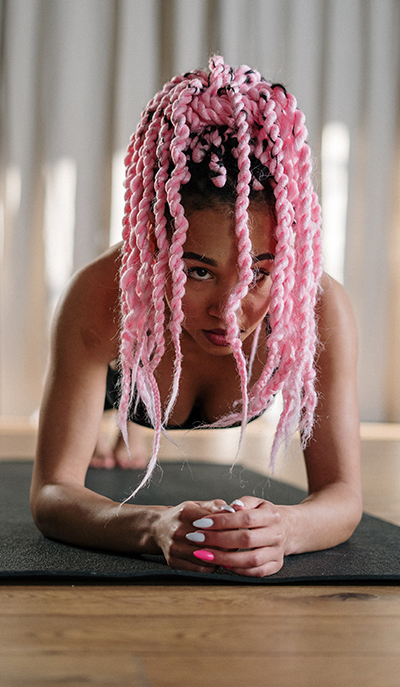 black woman pink hair in plank position