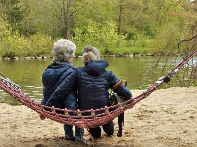 Older woman and young woman on a hommock next to a lake