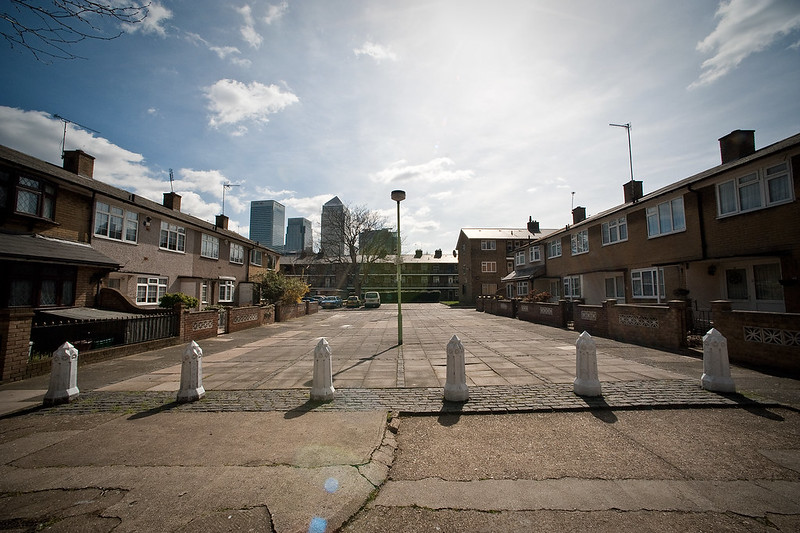 A photo of Pekin Close, in Poplar, a London estate road, Canary Wharf in the background