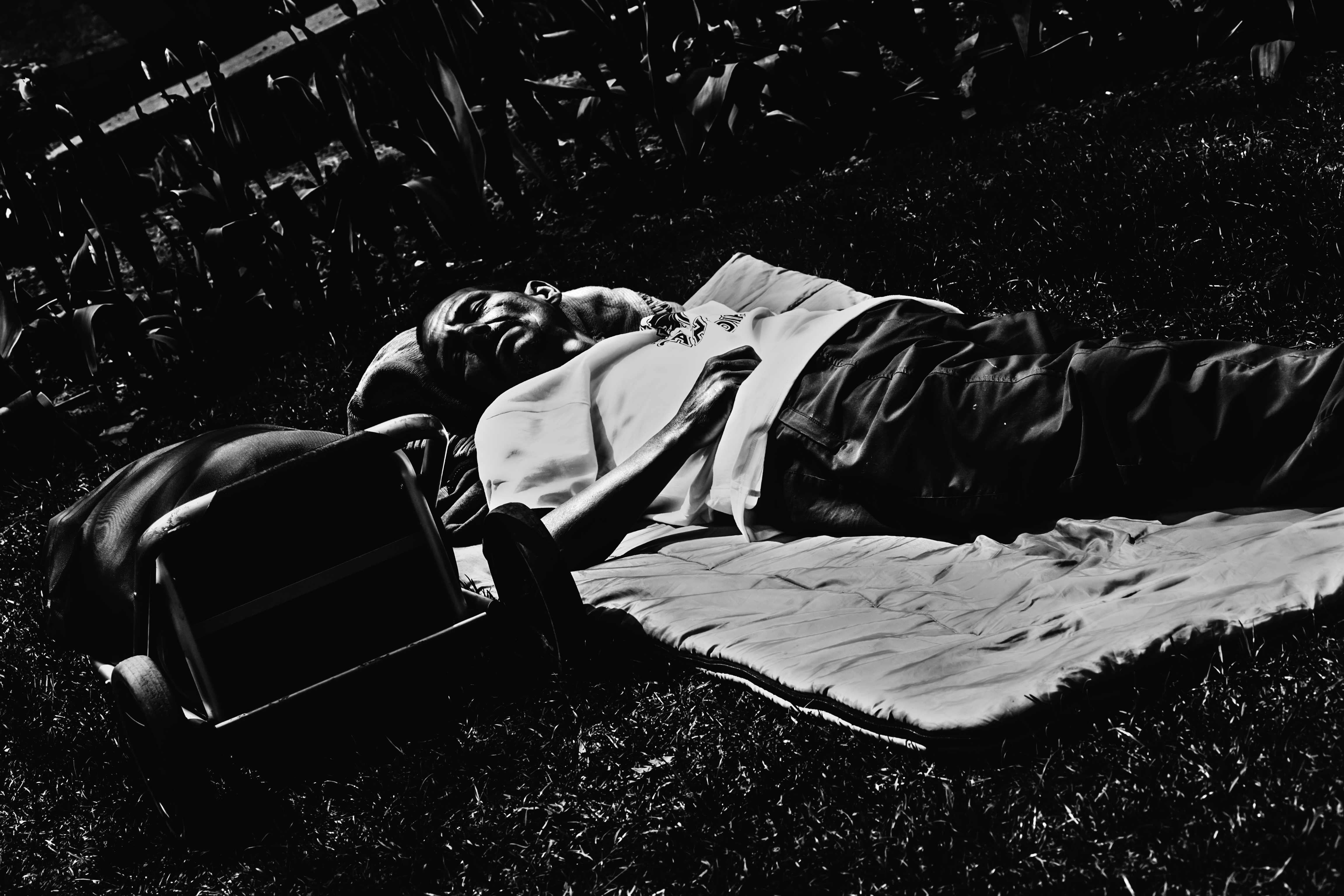 A homeless man sleeping in a park