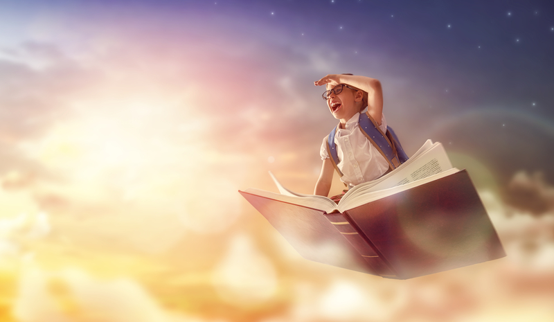 child flying on a book