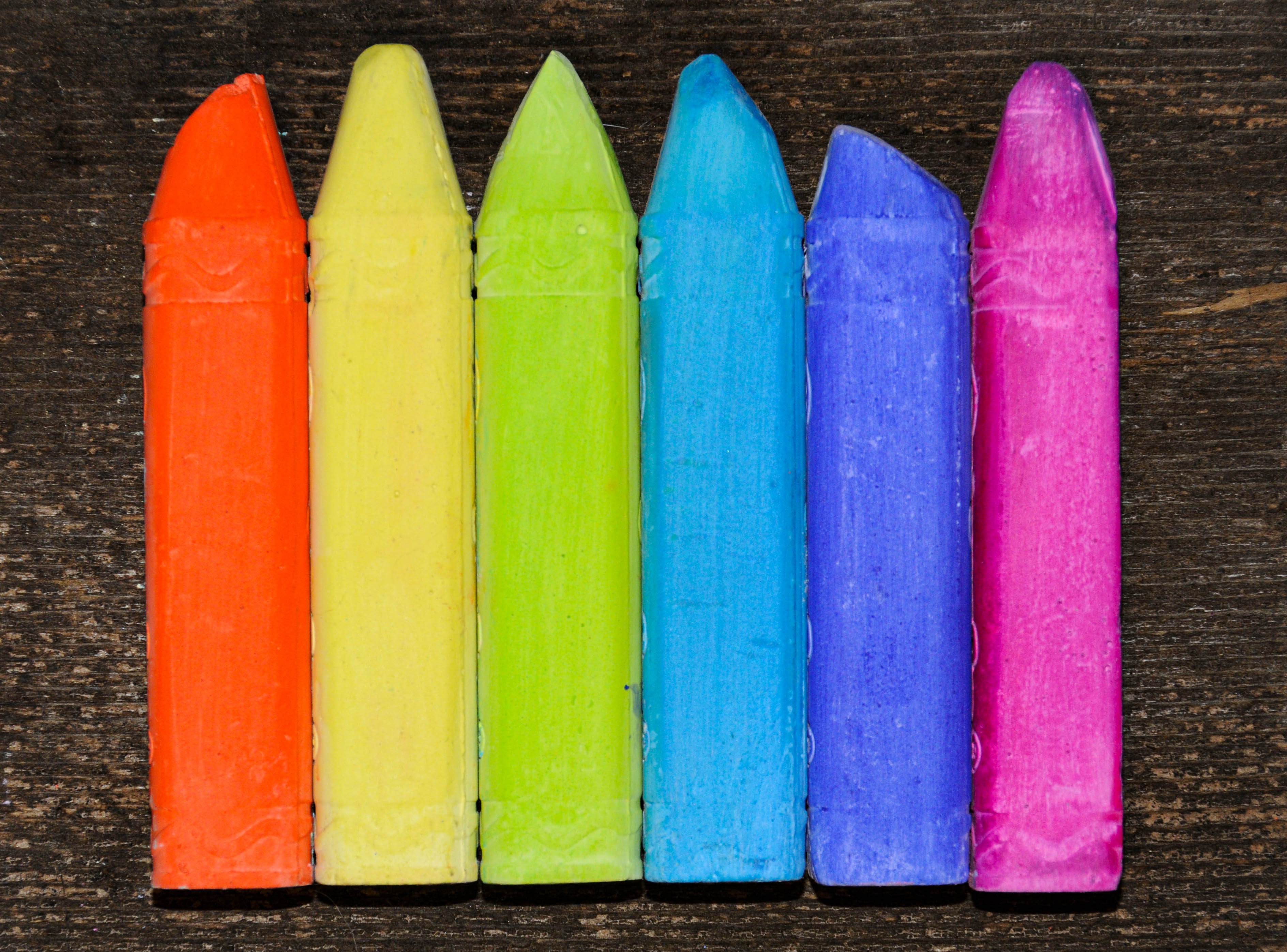 A row of crayons in rainbow flag colour