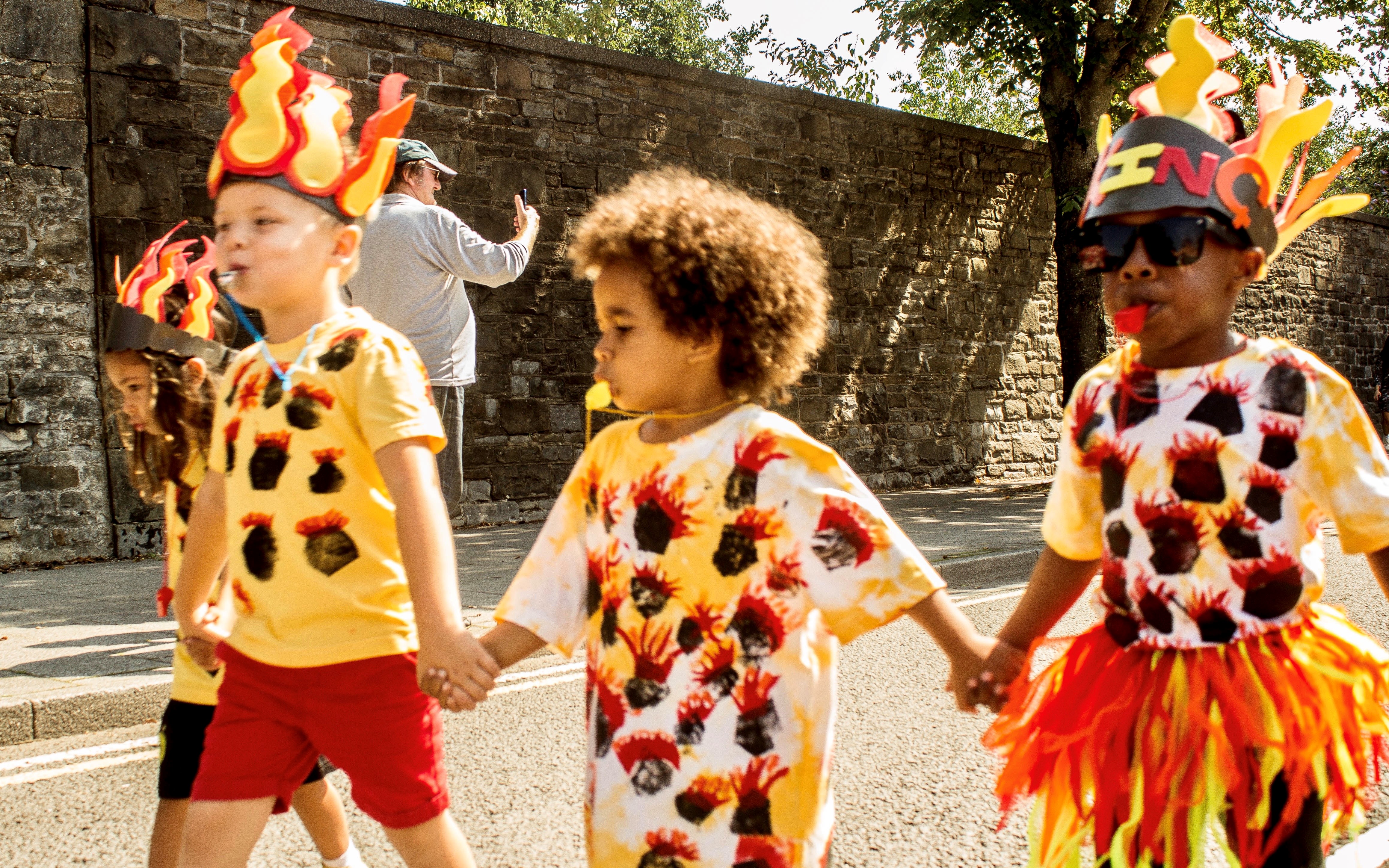 Children holding hands in Butetown Carnival parade