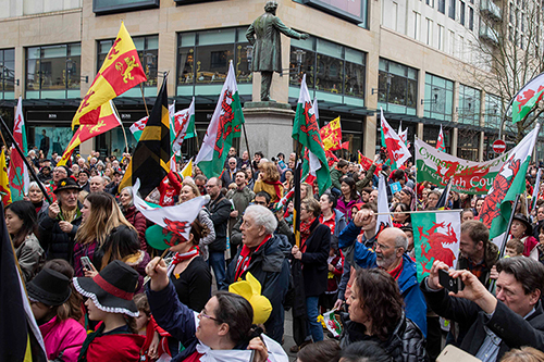 The crowd sings the Welsh national anthem at the 2019 St David's Day Parade in Cardiff.