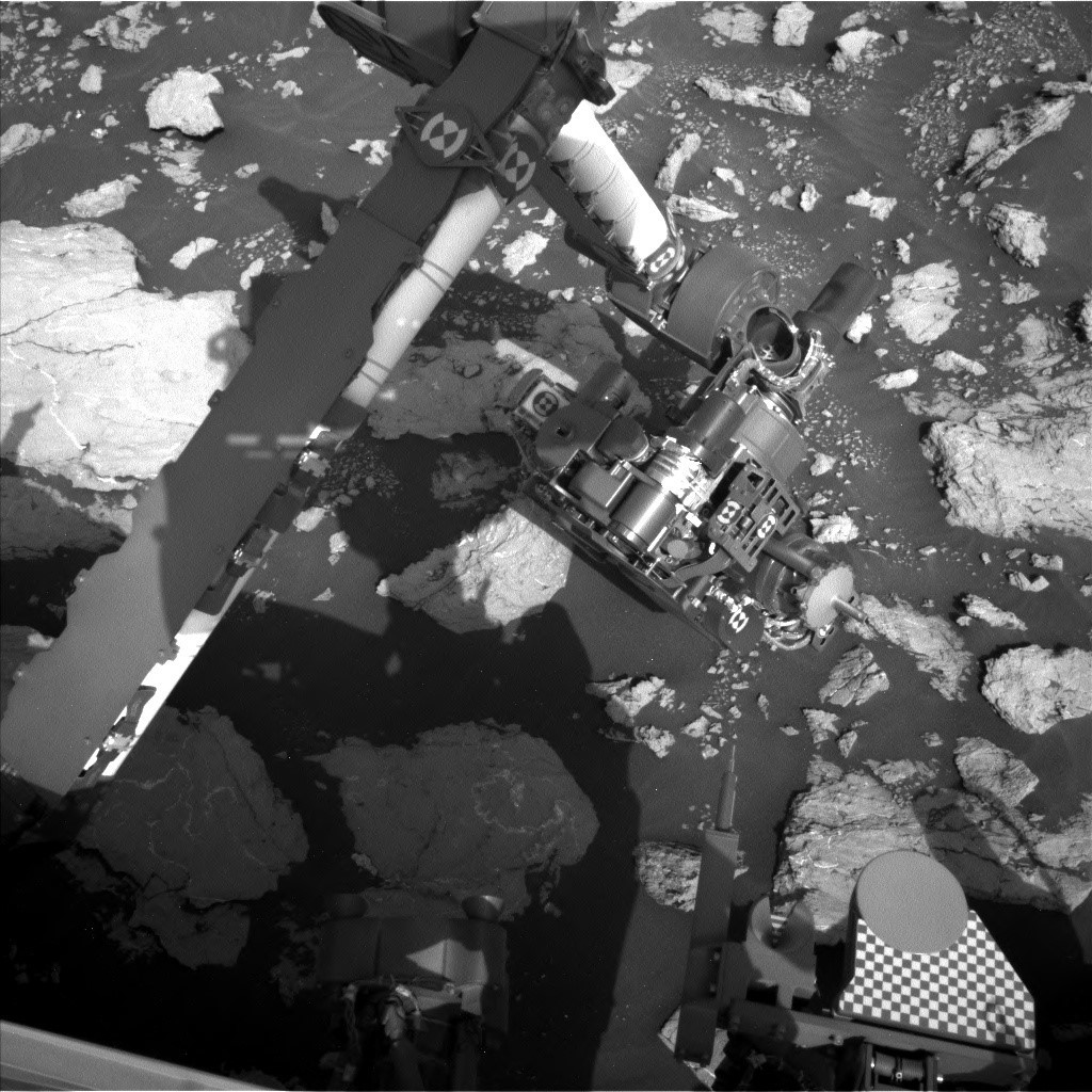 Curiosity rover - The left navigation camera looks down on the arm while it operates in the workspace.