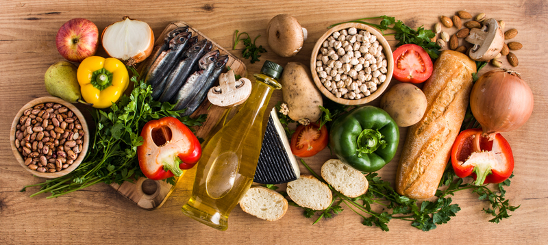 Mediterranean diet. Fruit, vegetables, grain, nuts olive oil and fish on wood