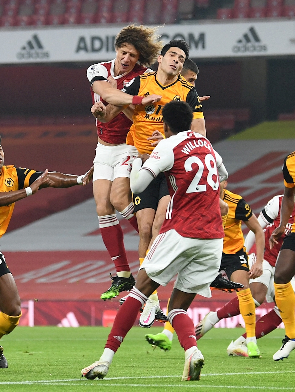 David Luiz of Arsenal clashes heads with Raul Jimenez of Wolves during the Premier League match between Arsenal and Wolverhampton Wanderers at Emirates Stadium on November 29, 2020