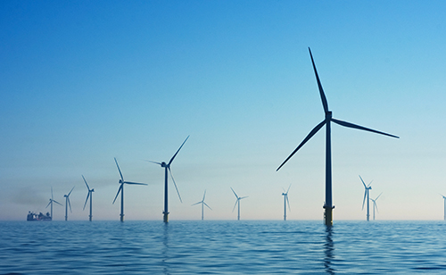 Photo of wind turbines in an Offshore wind farm in the United Kingdom.