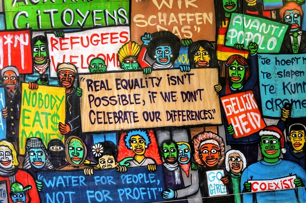 A poster featuring protest messages such as 'Real equality isn't possible, if we don't celebrate our differences'