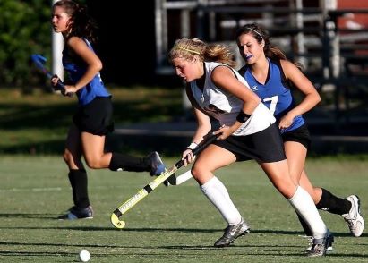 Young women playing hockey