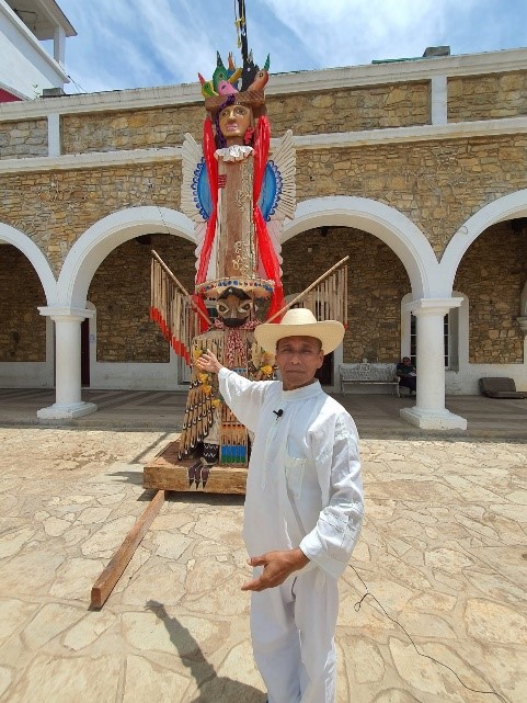 Jun Tiburcio standing with his creation: Totem Latamat