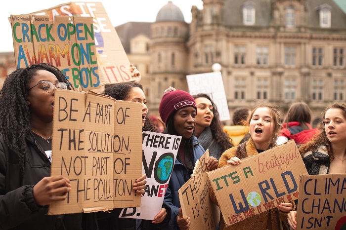A group of young people holding signs at a protest