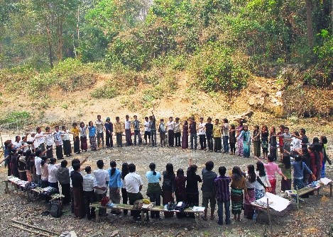 A group of people gather in a religious circle
