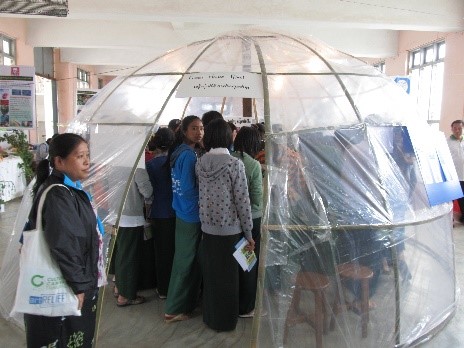 People inside a plastic shelter