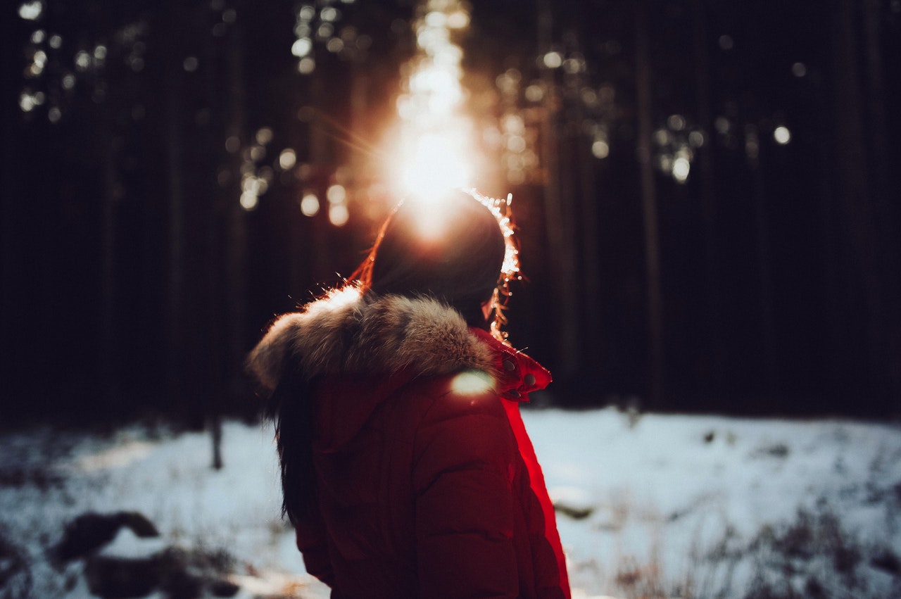 Woman in red coat in the winter sun