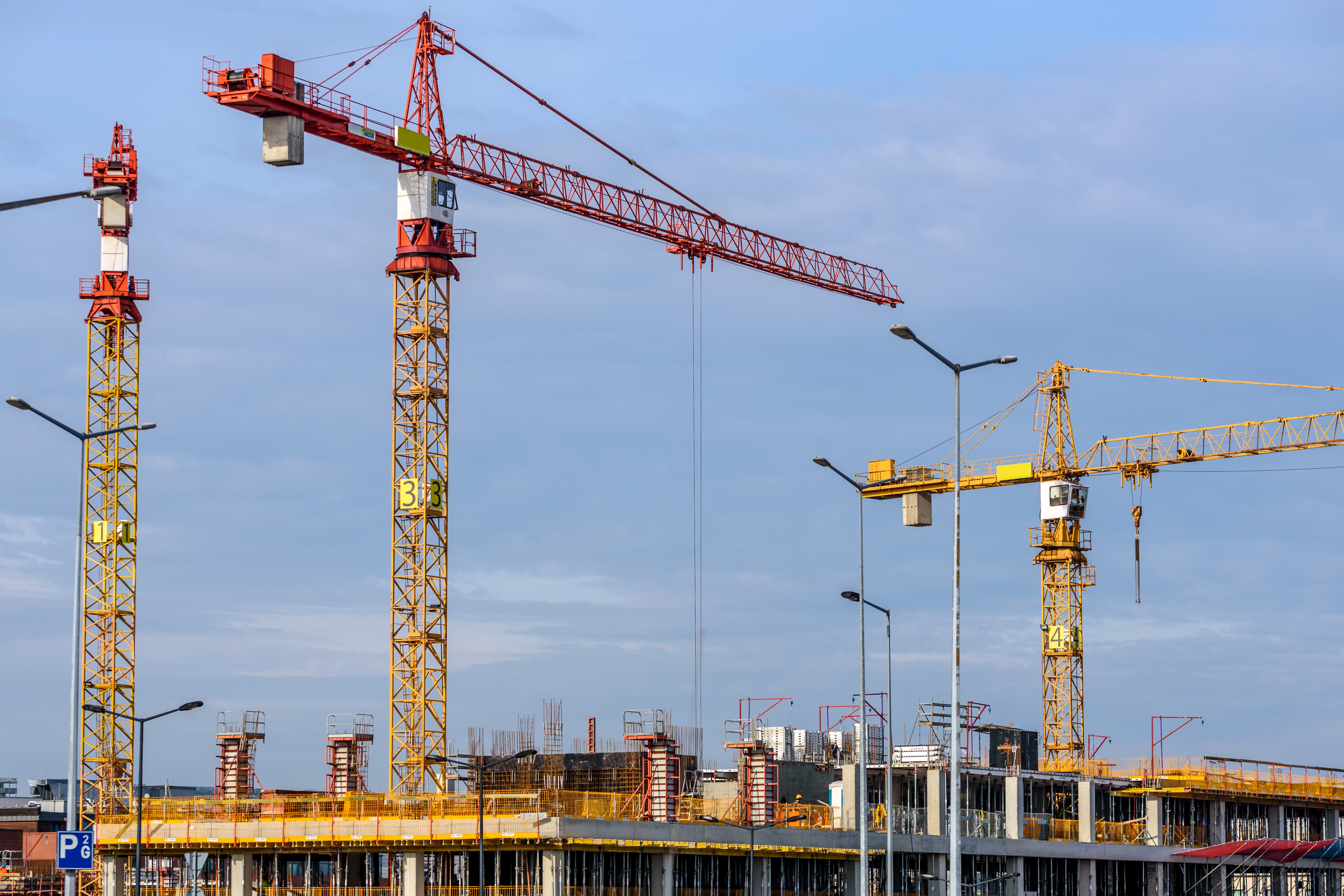 Construction site, sky full of cranes