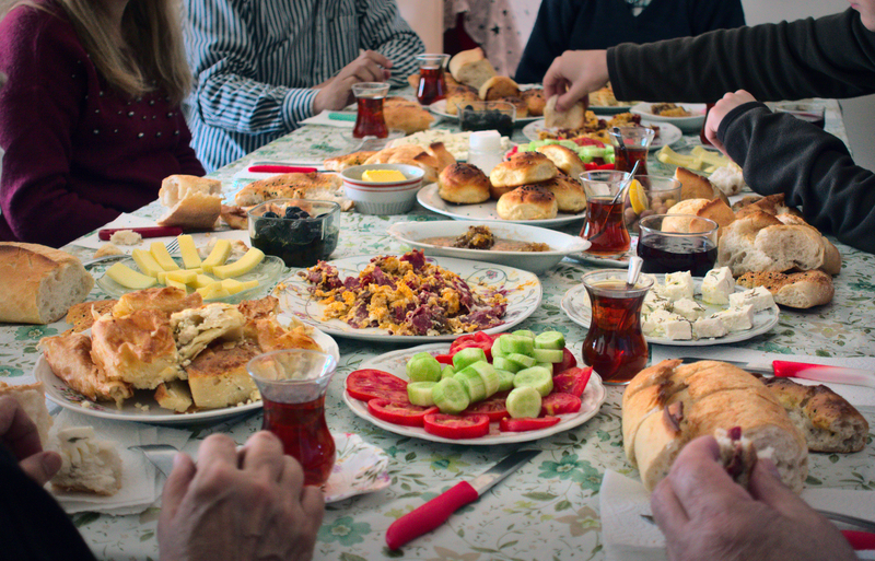 Turkish Muslim family having breakfast together traditional serpme kahvalti to celebrate Eid-ul-fitr.