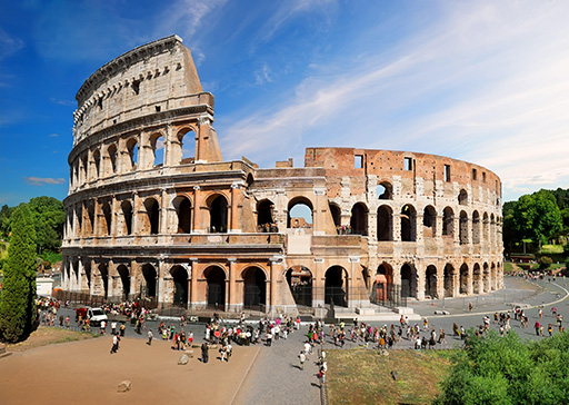 This is a colour photograph of the Colosseum in Rome, with visitors.