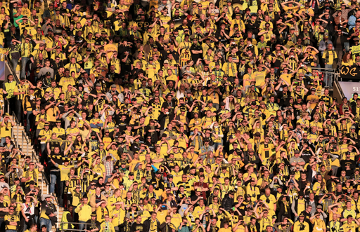 A photograph of a crowd of football fans, most of whom are wearing yellow.