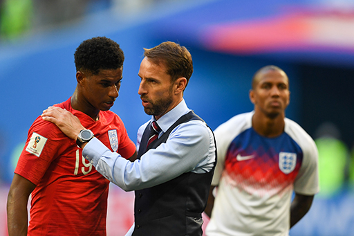 A photograph of Gareth Southgate with his hands on the shoulders of Marcus Rashford.