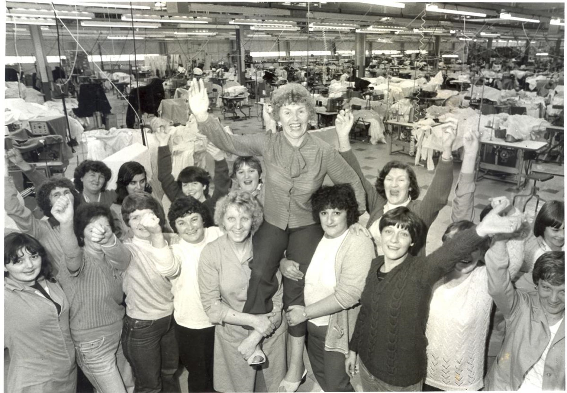With victory secured, Lee Jeans workers hold shop steward Helen Monaghan aloft in celebration, August 1981.