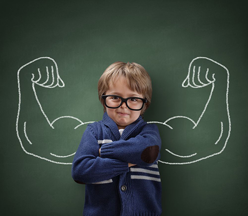 Young boy with arms folded across chest. Two muscular arms flexing are drawn where boy’s arms would be if doing same stance.