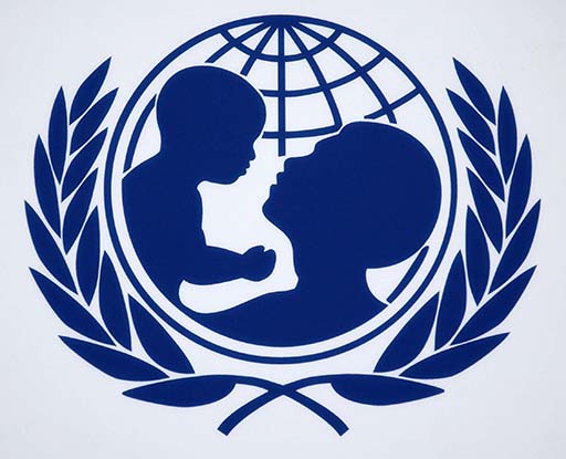 UNICEF logo: a silhouette of an adult’s head and an infant child being held up by the adult. Both are encased by a circle representing Earth and two strands of wheat.