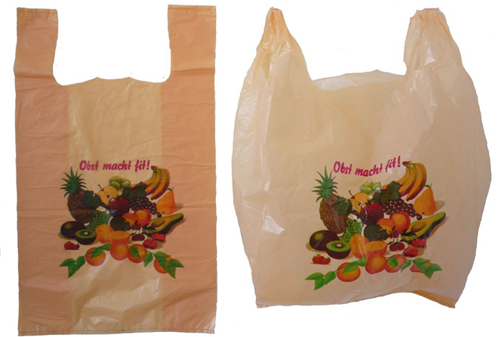 Photograph, colour. Two plastic bags next to each other, each with a printed illustration of various types of fruit.