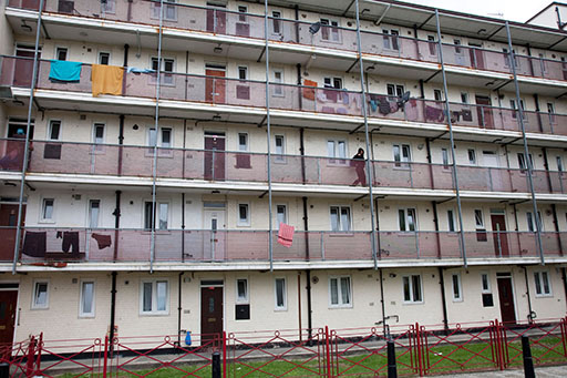 Block of flats on a housing estate – laundry is hanging over the balconies of some of the flats.