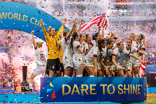 A photograph of the US women’s national team celebrating winning the world cup.