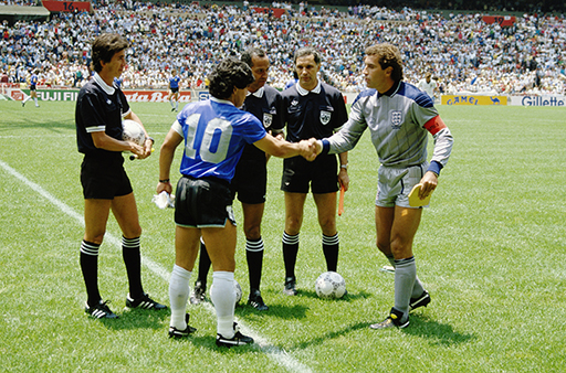 A photograph of the Argentina and England captains shaking hands alongside the officials.