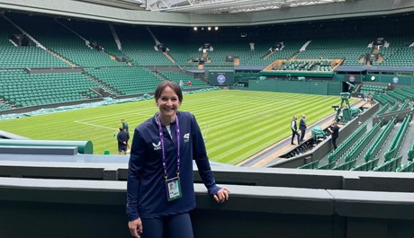 Samantha Parsons standing in front of Centre Court at Wimbledon.