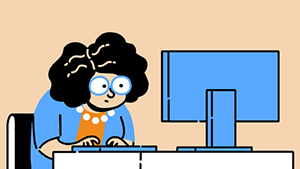 Жінка, яка працює за комп’ютером.